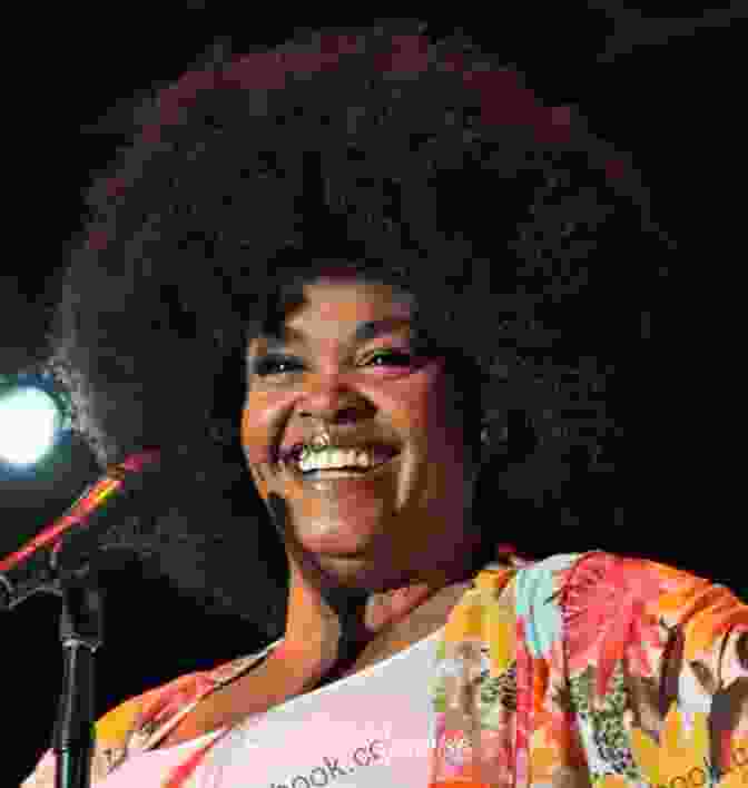 A Photograph Of Jill Scott, A Renowned Poet, Singer, And Songwriter, In A Pensive Pose, Surrounded By Books And A Lush Backdrop. The Moments The Minutes The Hours: The Poetry Of Jill Scott